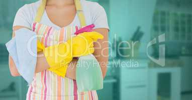 Cleaner standing with spray bottle in kitchen
