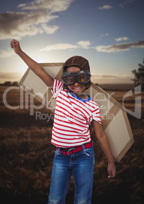 Portrait of smiling kid pretending to be a pilot in field