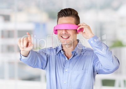 Man using virtual reality glasses against office window in background