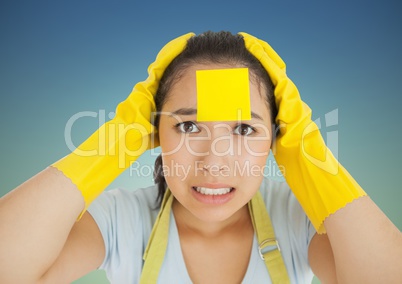Stressed woman in rubber gloves with blank sticky note on her forehead