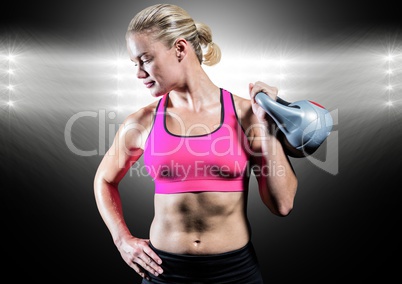 Athlete with hand on hip holding kettlebell