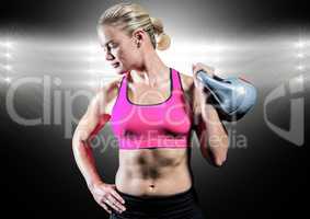Athlete with hand on hip holding kettlebell