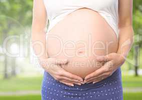 Close-up of pregnant woman holding her belly