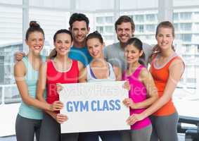 Portrait of happy people holding placard with text gym class