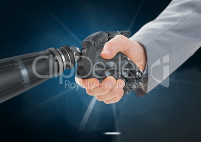 Businessman shaking hands with robot against dark blue background and white light