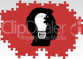 Silhouette of a mans head with a light bulb and jigsaw puzzle