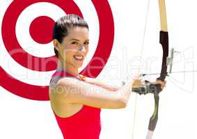 Portrait of woman aiming with bow and arrow at target