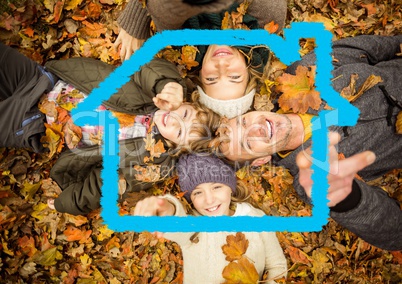 Happy family lying on dry leaves