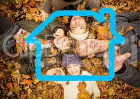 Happy family lying on dry leaves