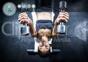 Fit woman perfroming flat bench exercise in gym against fitness interface i n background