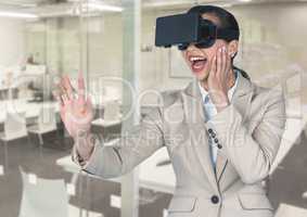 Digital composite image of smiling businesswoman using virtual reality headset