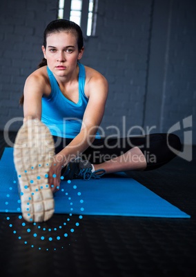 Portrait of woman exercising on mat