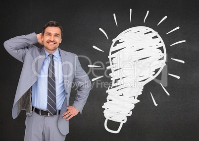 Digital composite image of businessman standing next to light blub