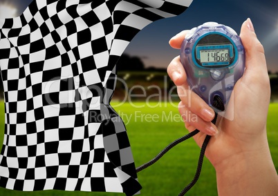 Stopwatch and checkered flag against stadium in background
