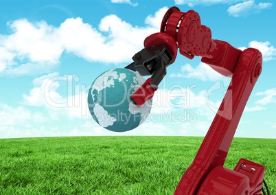 Red robot claw holding globe against green grass field and sky