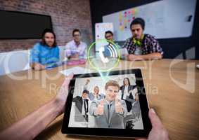 Man having a video with his colleagues on digital tablet