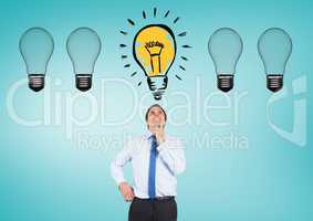 Thoughtful man looking at glowing electric bulb against blue background