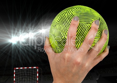 Hand holding a handball in stadium