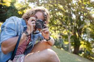 Man taking picture with digital camera