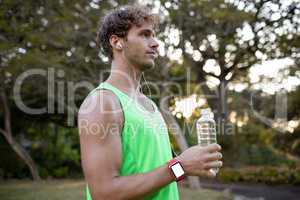 Jogger holding water bottle in park