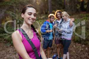 Smiling woman hiking with her friends