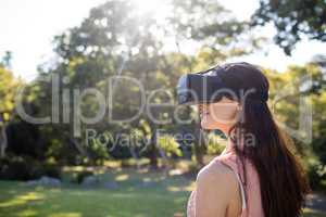 Woman using a VR headset in the park