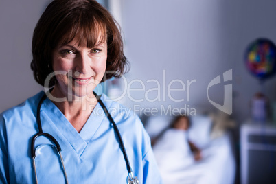 Portrait of female doctor standing in ward