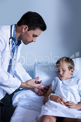 Male doctor injecting patient