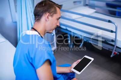 Doctor using digital tablet in ward