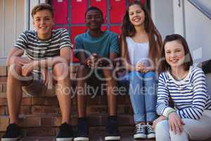 Portrait of students sitting on staircase