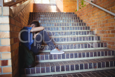 Attentive schoolgirl reading book in library