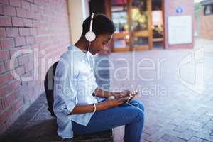 Schoolgirl listening music on mobile phone