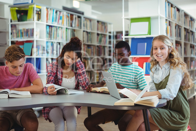 Attentive classmates studying in library