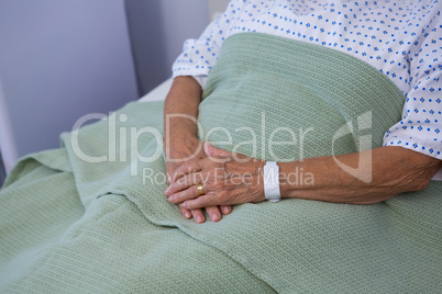 Senior patient relaxing on bed