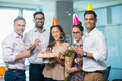 Portrait of smiling business colleagues celebrating birthday