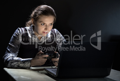 Sticking out tongue woman playing video games