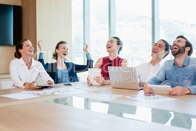 Smiling business executive having fun in conference room