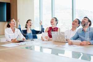 Smiling business executive having fun in conference room