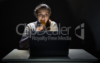 Woman watching movie and eating snack