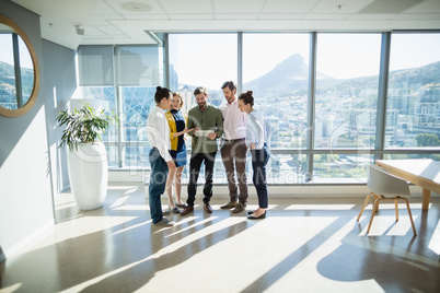 Business executives discussing over digital tablet