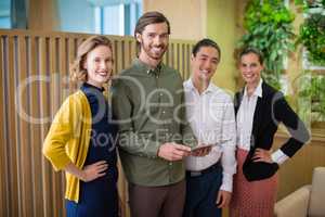 Business executives smiling while standing in office