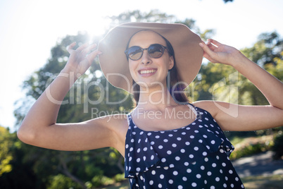 Happy woman wearing sunglasses and hat