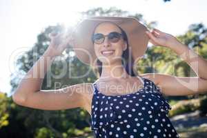 Happy woman wearing sunglasses and hat