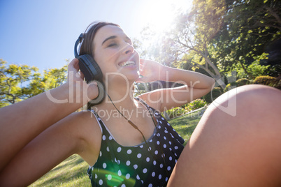 Smiling woman listening to music with headphones