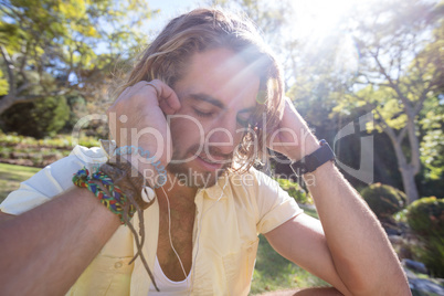 Close-up of man listening to music with earphone