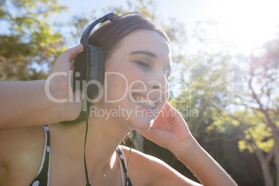 Smiling woman listening to music with headphones