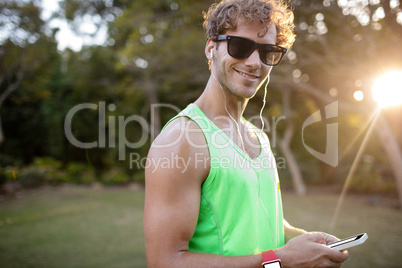 Happy man listening to music on mobile phone