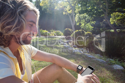 Happy man listening to music on mobile phone