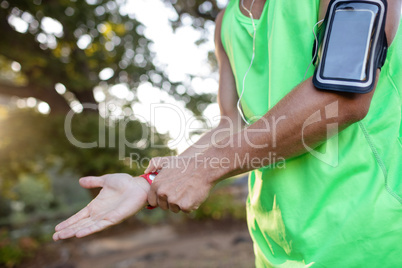 Jogger checking her fitness band