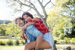 Man giving a piggyback ride to woman